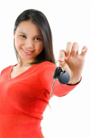 Happy Asian woman showing her new car key, isolated on white, focus on car key Stock Photo - Budget Royalty-Free & Subscription, Code: 400-06107322