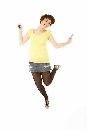 Studio Portrait Of Teenage Girl Jumping In Air Stock Photo - Budget Royalty-Free & Subscription, Code: 400-06107376