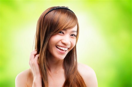 Cheerful Asian female combing her hair using finger Stock Photo - Budget Royalty-Free & Subscription, Code: 400-06108505