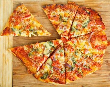 A delicious homemade pizza on a wooden chopping board. Stock Photo - Budget Royalty-Free & Subscription, Code: 400-06108703