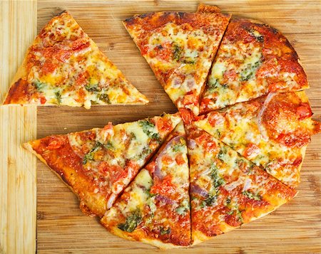 simsearch:400-07918516,k - A delicious homemade pizza on a wooden chopping board. Stock Photo - Budget Royalty-Free & Subscription, Code: 400-06108703