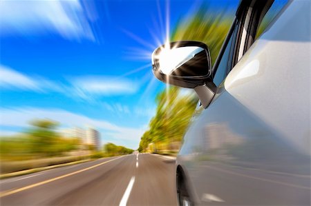 car on the road with motion blur and sunlight in the mirror Stockbilder - Microstock & Abonnement, Bildnummer: 400-06100150