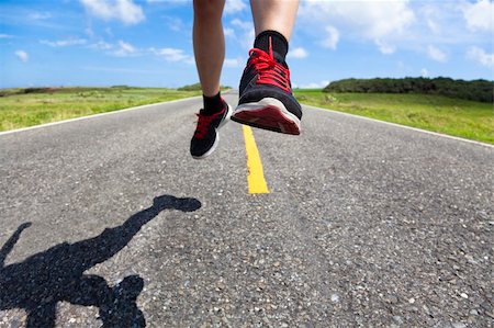 running with running shoes on a running track - closeup of running legs on the road Stock Photo - Budget Royalty-Free & Subscription, Code: 400-06100152