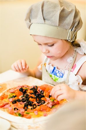 Little girl adding ingredients, vegetables and meat, in pizza Stock Photo - Budget Royalty-Free & Subscription, Code: 400-06101605