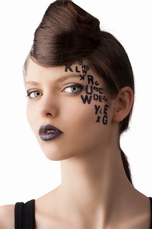 very cute young girl with letter and number painted on her face and a nice creative hair style, she is turned of three quarters at right and looks in to the lens Stock Photo - Budget Royalty-Free & Subscription, Code: 400-06101804