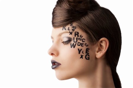 very cute young girl with letter and number painted on her face and a nice creative hair style, she is turned in profile at right and looks down Stock Photo - Budget Royalty-Free & Subscription, Code: 400-06101805