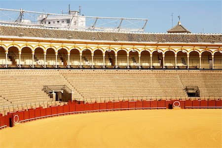 plaza de toros andalucia - Plaza de toros de la Real Maestranza de Caballeria de Sevilla or simply Plaza de Toros of Seville is the oldest bullring in Spain. It was built in stone and wood beetween 1749 and 1881. In this place, every year takes place the famous Feria de Abril. Stock Photo - Budget Royalty-Free & Subscription, Code: 400-06101844