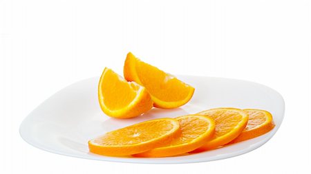 some peaces of orange on a plate isolated on a white Photographie de stock - Aubaine LD & Abonnement, Code: 400-06102305