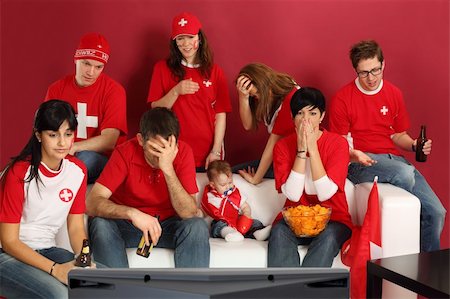 Photo of Swiss sports fans watching television and being disappointed with the game. Stock Photo - Budget Royalty-Free & Subscription, Code: 400-06102435