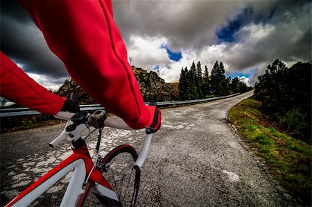 detached - Cyclist on road bike through a asphalt road in the mountains and blue sky with clouds. Stock Photo - Budget Royalty-Free & Subscription, Code: 400-06102463