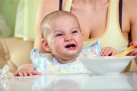 Young Caucasian woman feeding crying boy with spoon Stock Photo - Budget Royalty-Free & Subscription, Code: 400-06102936