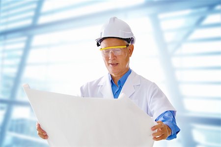 simsearch:400-05714957,k - Senior Asian engineer with blueprints office background Stock Photo - Budget Royalty-Free & Subscription, Code: 400-06103383