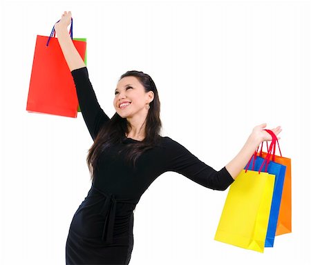simsearch:400-06092781,k - Happy shopper holding shopping bag high isolated on white background Photographie de stock - Aubaine LD & Abonnement, Code: 400-06103394