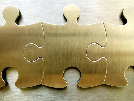 Three golden jigsaw close-up against a metallic background Stock Photo - Budget Royalty-Free & Subscription, Code: 400-06126756