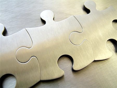 Three steel jigsaw close-up on a metallic background Stock Photo - Budget Royalty-Free & Subscription, Code: 400-06126757