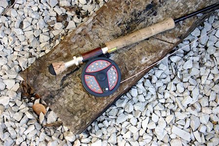 seriousfun (artist) - A fly fishing rod lying in a river bed. Fotografie stock - Microstock e Abbonamento, Codice: 400-06129167