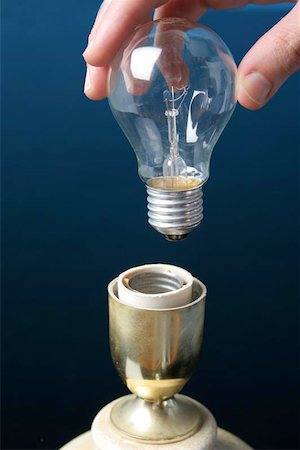 Hand putting a ligth bulb in a lamp Stock Photo - Budget Royalty-Free & Subscription, Code: 400-06129241