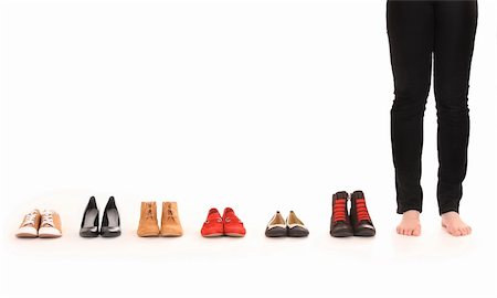 A picture of female legs among six pairs of shoes over white background Stock Photo - Budget Royalty-Free & Subscription, Code: 400-06135539