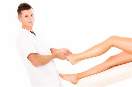 A picture of a physio therapist giving a leg massage over white background Fotografie stock - Microstock e Abbonamento, Codice: 400-06135547