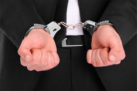 pictures of hands in handcuffs - A picture of a businessman in handcuffs Stock Photo - Budget Royalty-Free & Subscription, Code: 400-06135575