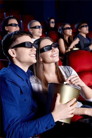 Young people in the cinema in 3D glasses Stock Photo - Budget Royalty-Free & Subscription, Code: 400-06135707