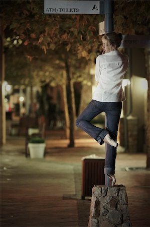 pole dancing images - Young adult blonde ballerina dancing at night under signs and lamp posts in a general urban area. Shallow Depth of Field Stock Photo - Budget Royalty-Free & Subscription, Code: 400-06135883