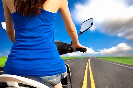 slim woman riding scooter with high speed on the road Stock Photo - Budget Royalty-Free & Subscription, Code: 400-06136023