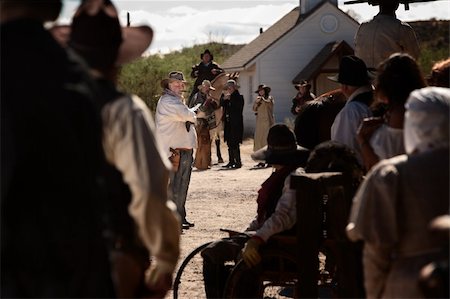 simsearch:400-06097059,k - Cocky gunfighter waves back crowd in an old west showdown Stock Photo - Budget Royalty-Free & Subscription, Code: 400-06136036