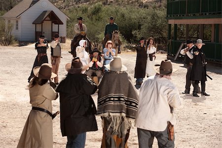 female guns in holsters - Group of cowboys and gunfighters in an old west shoot out Stock Photo - Budget Royalty-Free & Subscription, Code: 400-06136046