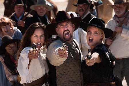 simsearch:400-05347613,k - Three gunfighters yell while shooting in outdoor old west scene Stock Photo - Budget Royalty-Free & Subscription, Code: 400-06136056