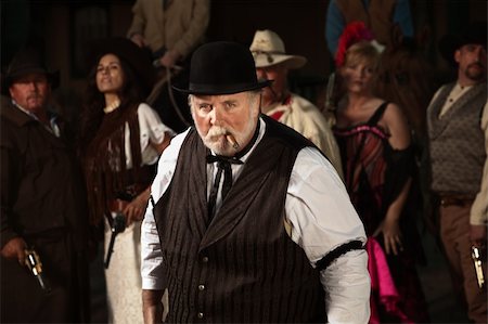 simsearch:400-06136085,k - Mean looking man with cigar in old American west costume Fotografie stock - Microstock e Abbonamento, Codice: 400-06136098