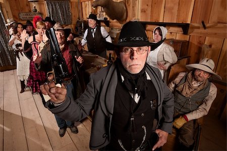 simsearch:400-06097059,k - Serious old west sheriff in bar with scared customers Stock Photo - Budget Royalty-Free & Subscription, Code: 400-06136537