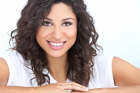 simsearch:400-04340722,k - Studio portrait of a beautiful young Latina Hispanic woman smiling Stock Photo - Budget Royalty-Free & Subscription, Code: 400-06136735