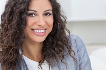 simsearch:400-04340722,k - Studio portrait of a beautiful young Latina Hispanic woman smiling Stock Photo - Budget Royalty-Free & Subscription, Code: 400-06136731