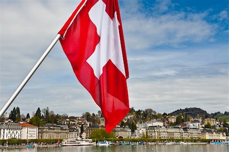 flagstaff - Swiss Flag on the Background of the Embankment of the River Reuss in Lucerne Stockbilder - Microstock & Abonnement, Bildnummer: 400-06137094