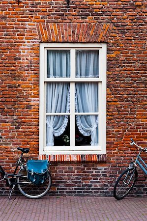 red brick building - Window with Curtain in the Dutch City Stock Photo - Budget Royalty-Free & Subscription, Code: 400-06137101