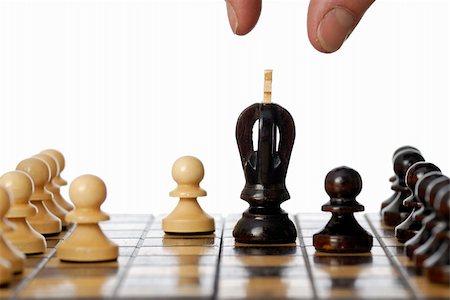 pawn chess piece - Fingers about to move the black King. Stock Photo - Budget Royalty-Free & Subscription, Code: 400-06137654