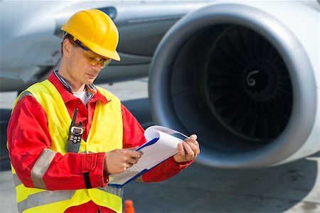 plane runway people - Airline safety engineer going through a pre-flight checklist Stock Photo - Budget Royalty-Free & Subscription, Code: 400-06137763