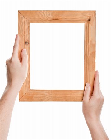 Wooden frame in hands isolated on white background Stock Photo - Budget Royalty-Free & Subscription, Code: 400-06137805