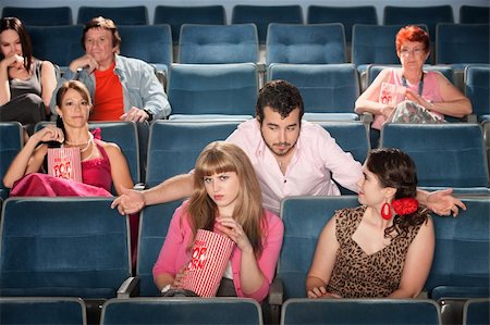 simsearch:400-06138368,k - Rude bearded man talking to ladies in a theater Stock Photo - Budget Royalty-Free & Subscription, Code: 400-06138365