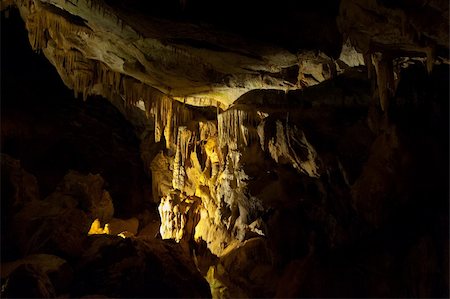 stalattite - Stalactite and Stalagmite in the Deep Dark Cave Fotografie stock - Microstock e Abbonamento, Codice: 400-06138598