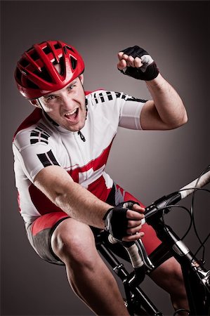 fully equipped cyclist riding a bicycle Foto de stock - Royalty-Free Super Valor e Assinatura, Número: 400-06138756