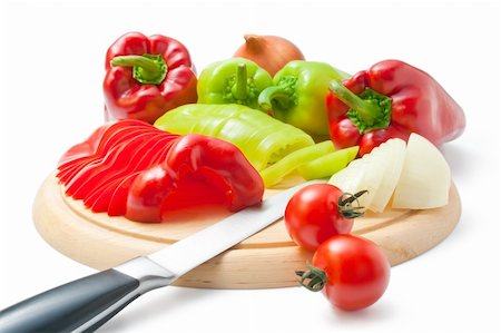 Fresh ripe red and green peppers and onions placed on a wooden cutting board and around arranged with kitchen knife and some cherry tomatoes isolated on white background. Stock Photo - Budget Royalty-Free & Subscription, Code: 400-06138990