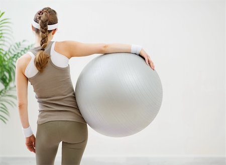 Athletic woman with fitness ball standing back to camera Stock Photo - Budget Royalty-Free & Subscription, Code: 400-06139222