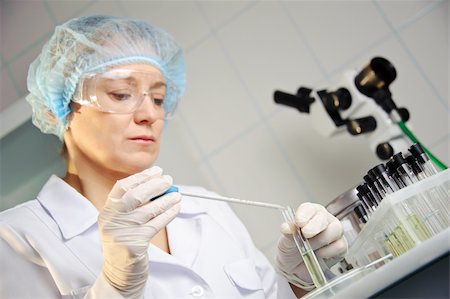 A female doctor examines a sample. Shallow depth of field. Focus on foreground, hands.  Could be useful for medicine, hospital, research and development, clinical studies, forensics, science etc Stock Photo - Budget Royalty-Free & Subscription, Code: 400-06139320