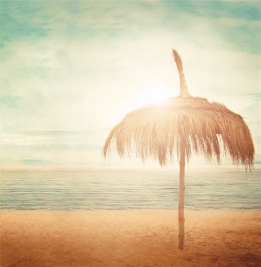 Straw parasol with cloudscape and calm sea water on sand beach on a tropic island Stock Photo - Royalty-Free, Artist: mythja, Image code: 400-06139538