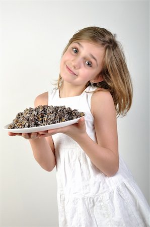 Young elementary girl with traditional European Christmas food kutia made of wheat or rice, poppyseeds, nuts, raisins and honey Photographie de stock - Aubaine LD & Abonnement, Code: 400-06139574