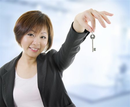 Mid adult Asian woman arms out holding a new key Stock Photo - Budget Royalty-Free & Subscription, Code: 400-06139709