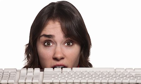 Anxious young Caucasian woman over white with keyboard in front Stock Photo - Budget Royalty-Free & Subscription, Code: 400-06139899