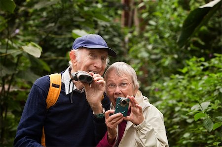 Two seniors with camera and binoculars in forest Stock Photo - Budget Royalty-Free & Subscription, Code: 400-06139902